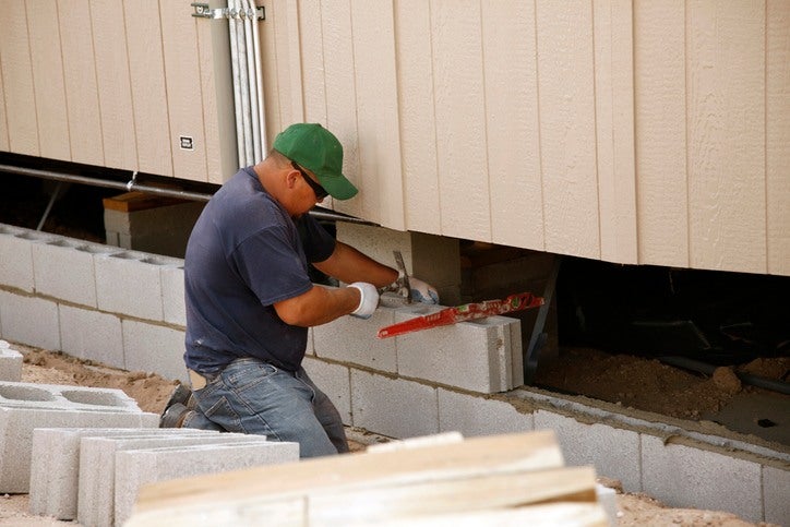Technician fixing underpinning foundation