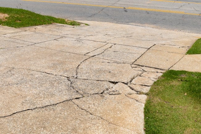 Cracked concrete surface showing signs of settlement and structural stress